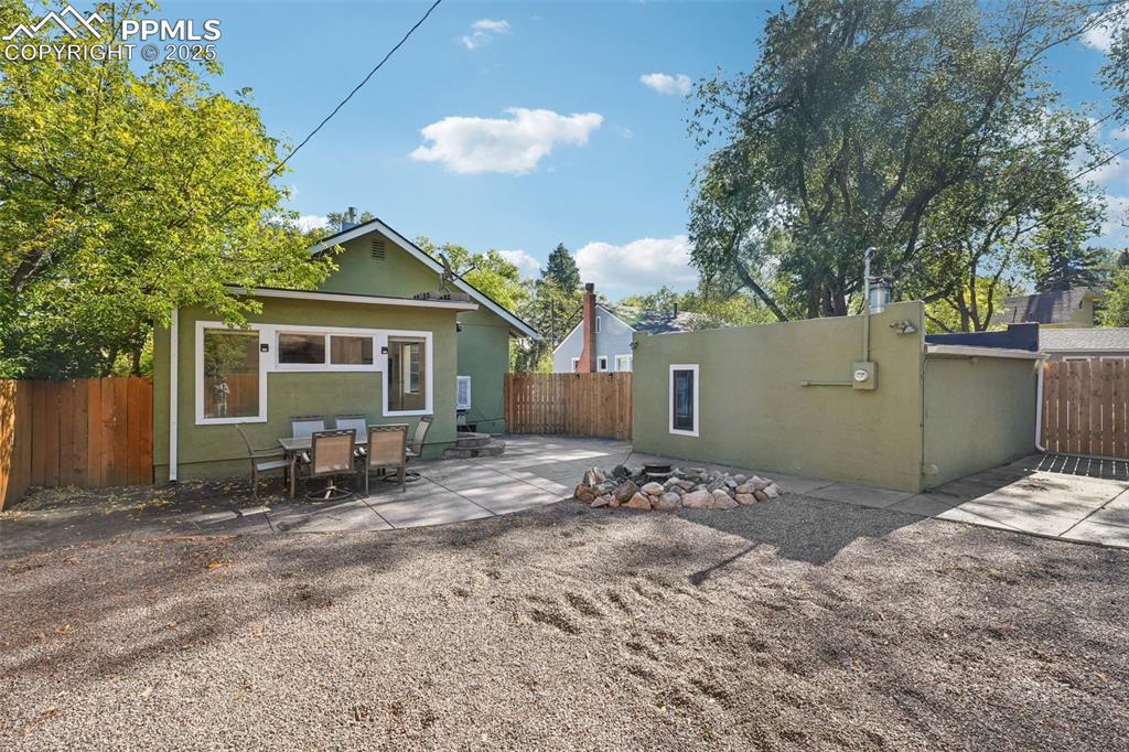 Xeriscaped backyard with spacious patio and fire pit 