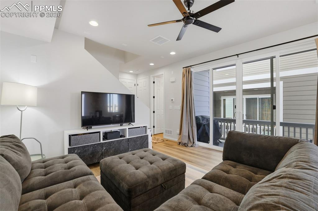 Living area featuring recessed lighting, light wood-style floors, and a ceiling fan