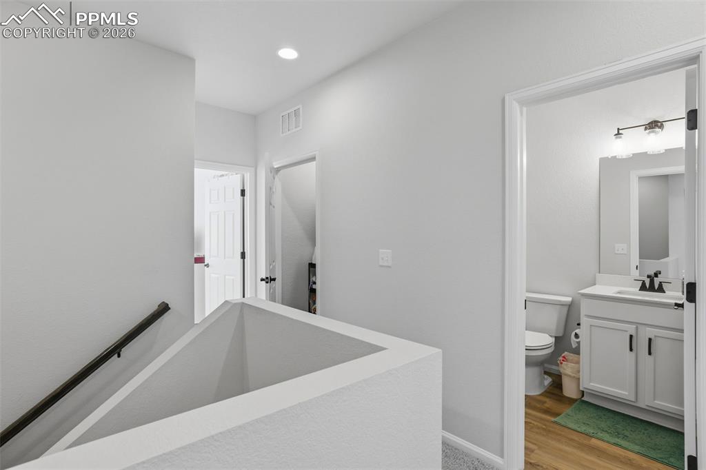 Bathroom with vanity, light wood-type flooring, and recessed lighting