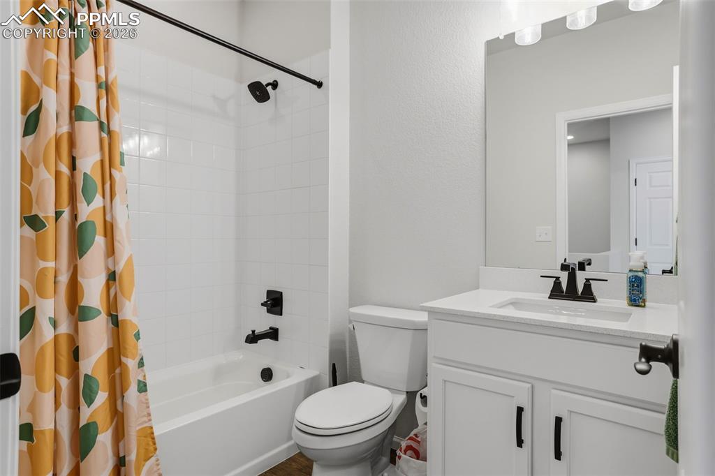 Bathroom with vanity and shower / tub combo with curtain