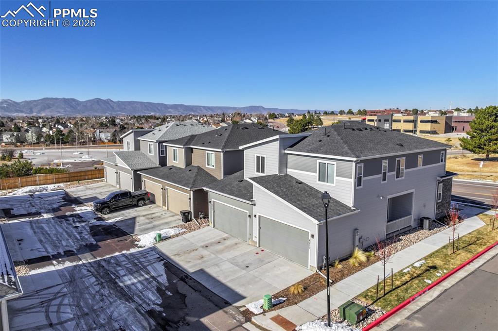 Aerial view of residential area featuring mountains