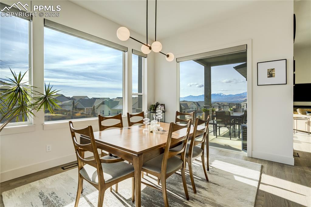 The Dining Area Flows Naturally from the Kitchen and Great Room, Positioned to Take in Sweeping Pikes Peak Views Through Expansive Glass. Its Open Placement Allows for Seamless Entertaining while Maintaining a Distinct Sense of Place Within the Home’s Architectural Framework.
