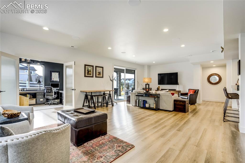 Recreation Room Offers 9-Foot Ceilings, Abundant Natural Light, and LVP Flooring for Durability and Style. Integrated Surround Sound Enhances Gatherings and Movie Nights, While Dimmable Lighting Allows the Ambiance to Shift Effortlessly from Vibrant Entertaining to a Relaxed Evening Retreat