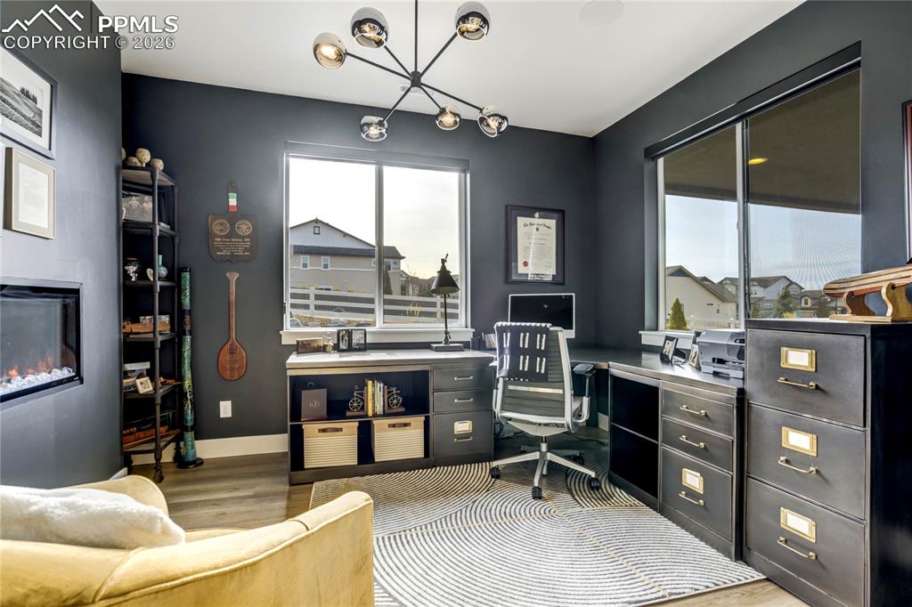 Framed by Mountain Views and Enclosed with French Doors, the Office Balances Productivity and Comfort. A Modern Electric Fireplace Introduces Architectural Warmth, While Integrated Surround Sound and Dimmable Lighting Allow the Space to Transition Seamlessly from Focused Work Environment to Relaxed Evening Retreat