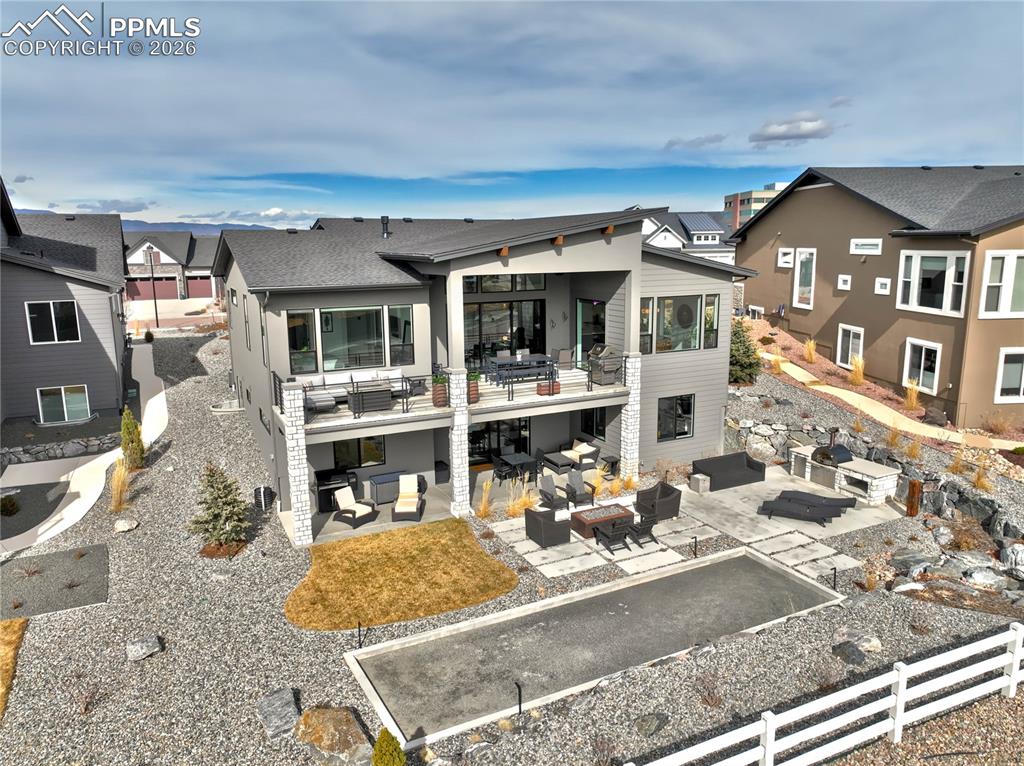 Outdoor Living, Reimagined—A Bocce Court, Dual-Fuel Alpha Pizza Oven (wood + gas), Built-in Outdoor Kitchen, Black Granite Pondless Water Feature, Modern Pavers with Fire-pit, Expansive Concrete Covered Decks, Patios + Sun Decks with Surround Sound Extend the Living Experience Outdoors - framed by Sweeping Mountain Views on a .29 Acre Executive Lot w/Nearby Access to Community Trail System