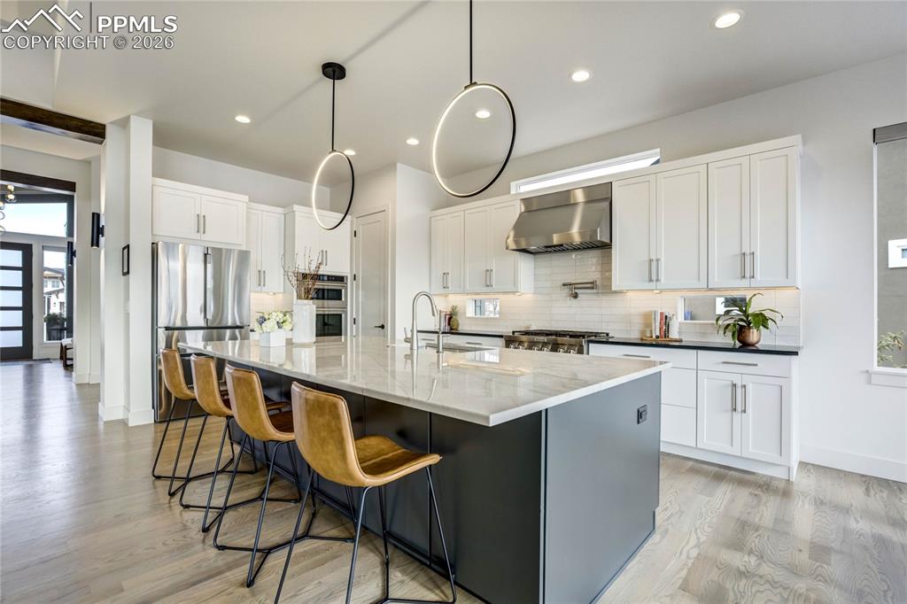 Alder Wood Beams, 3¼” red oak floors in a Sophisticated Grey Taupe Ground the Home in Warmth and Quiet Luxury