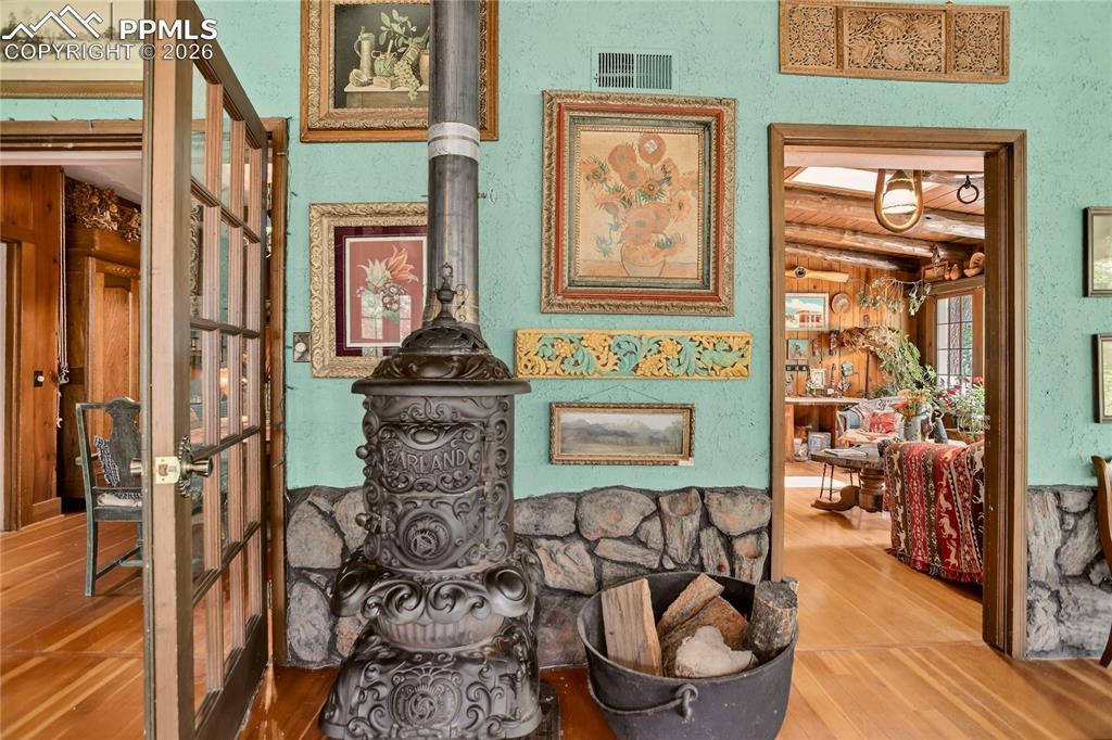 Access to den & dining room. Original wood stove.