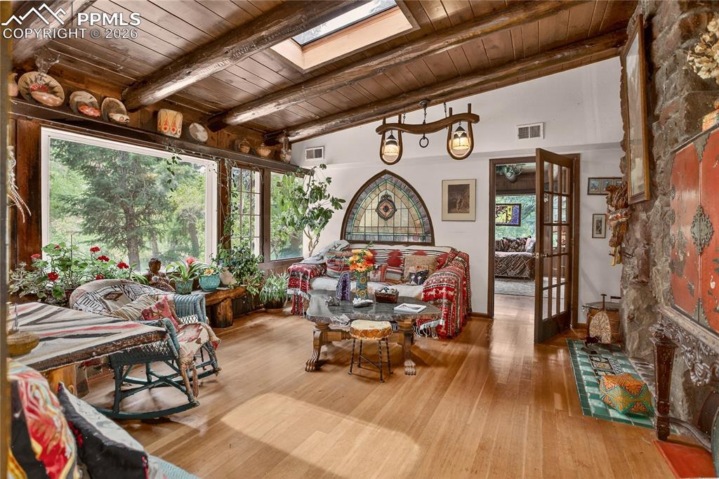 Den with moss rock fireplace