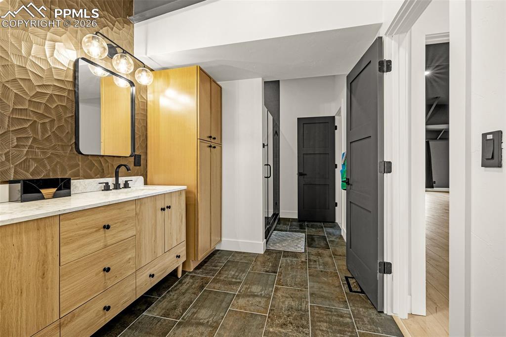 Primary bathroom with entrance from primary bedroom and sun room. Upper Level.