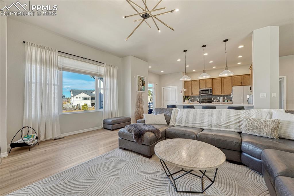 Living room opens to kitchen with walkout to west facing deck
