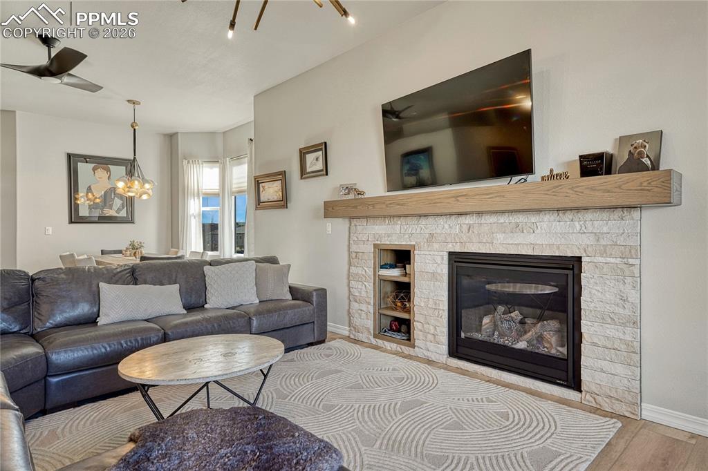 Stone surround gas fireplace with chunky modern mantel