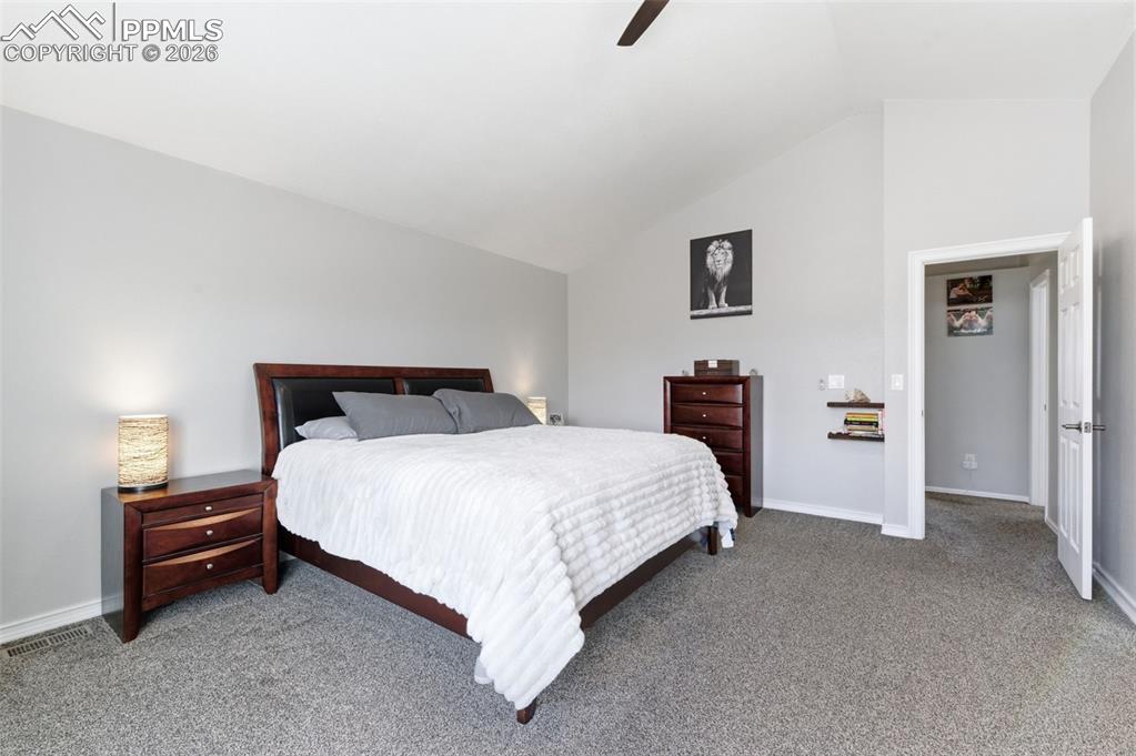 Vaulted ceiling and ceiling fan really keep this primary bedroom open and light