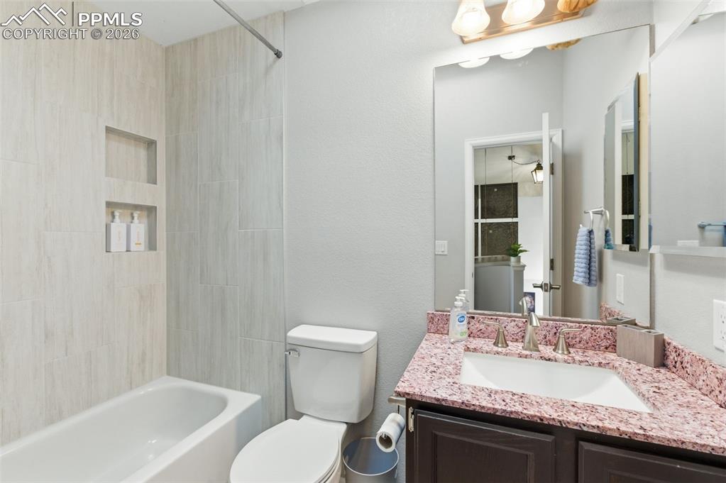 The hall bath has beautiful tile surround and granite countertop and serves the secondary upstairs bedrooms