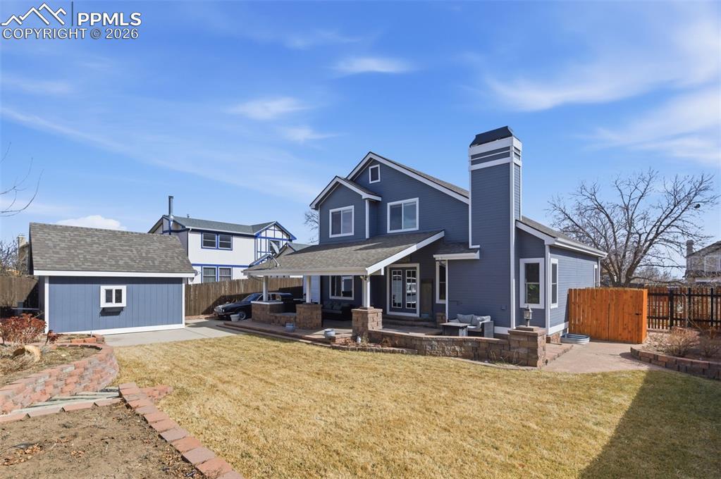 Thoughtfully and creatively designed, the backyard offers full landscaping with garden areas and access to the front