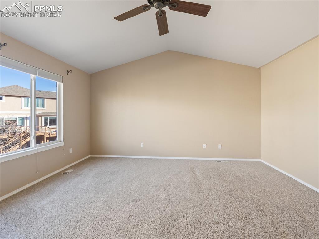 Primary bedroom featuring carpet floors and ceiling fan
