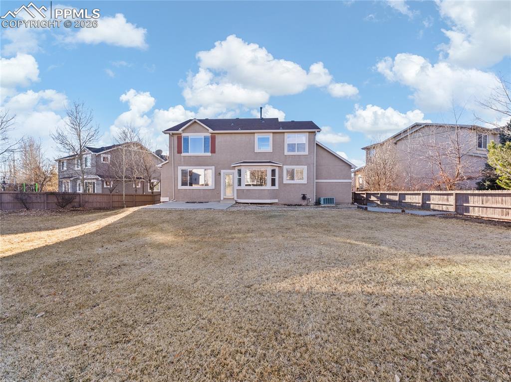 Back of property featuring a fenced backyard and a patio area