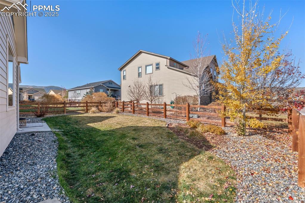 Fenced backyard featuring a residential view