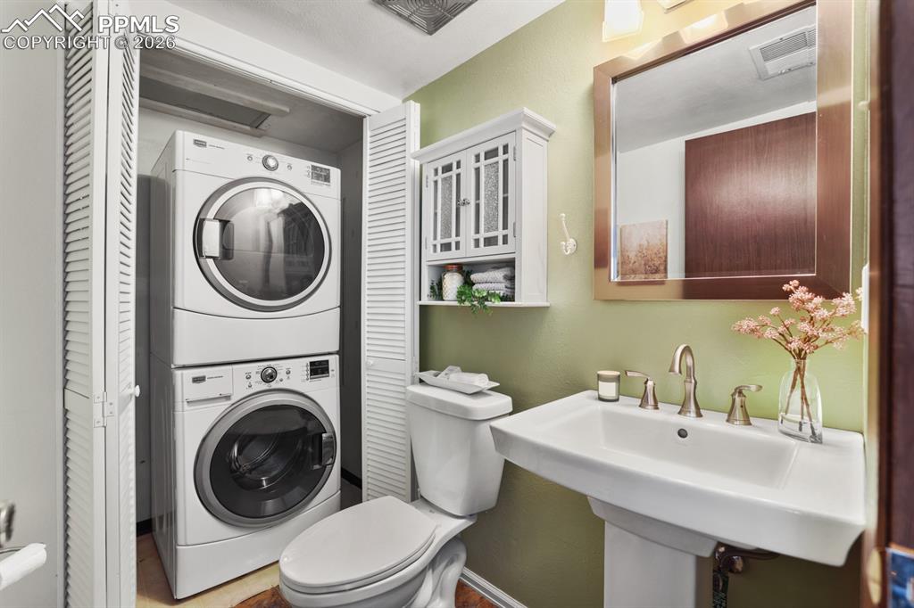 Main Level Powder Bathroom and Laundry Closet with washer and dryer that stay.