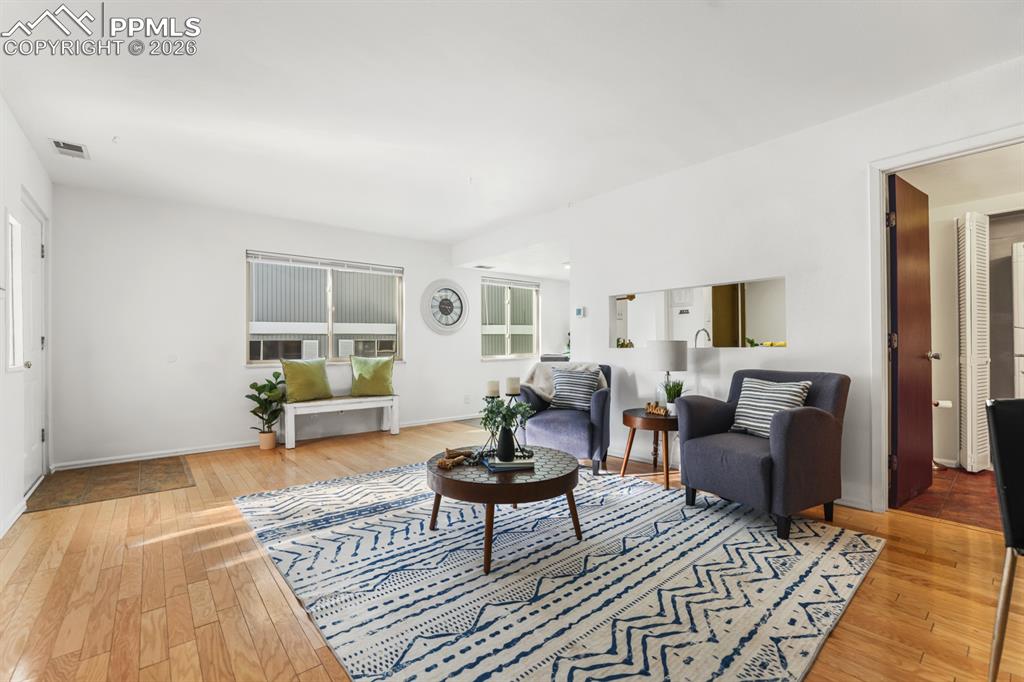 The spacious living room has a warm & inviting atmosphere perfect for gatherings.