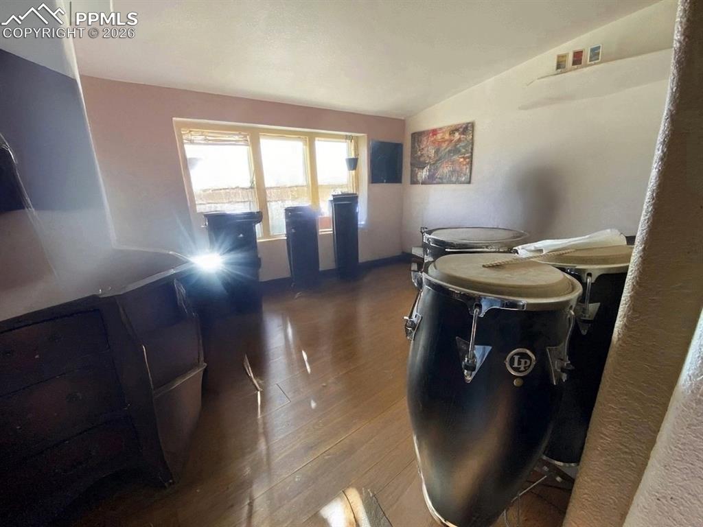 Dining space with dark wood-type flooring and lofted ceiling
