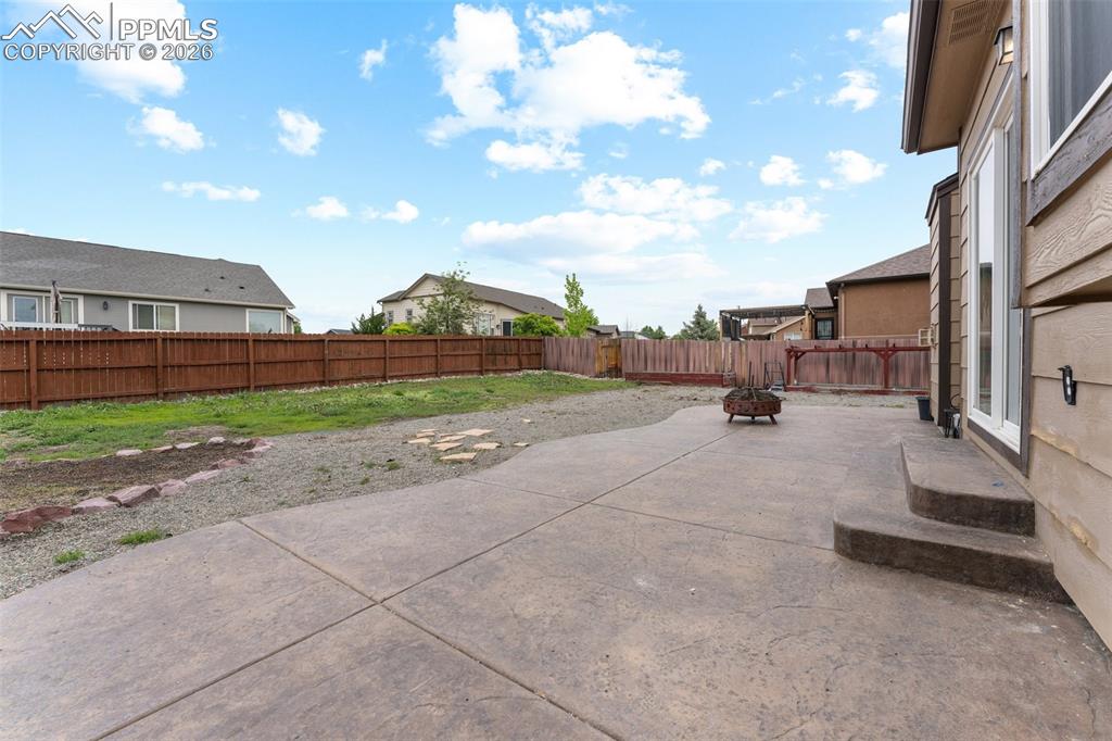 Backyard includes Stamped Concrete Patio, Dedicated Dog Run , Garden Bed Area and Plenty of Space to Play