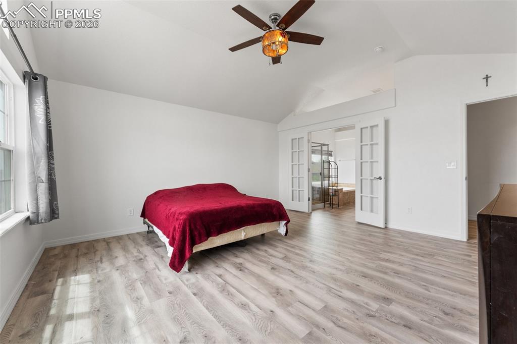 Primary Bedroom with Vaulted Ceiling, French Doors for En-suite and Walk-In Closet 