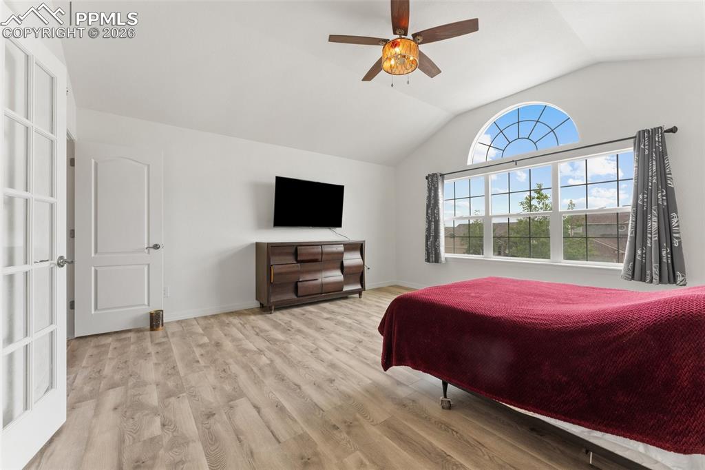 Primary Bedroom with Vaulted Ceiling, French Doors for En-suite and Walk-In Closet 