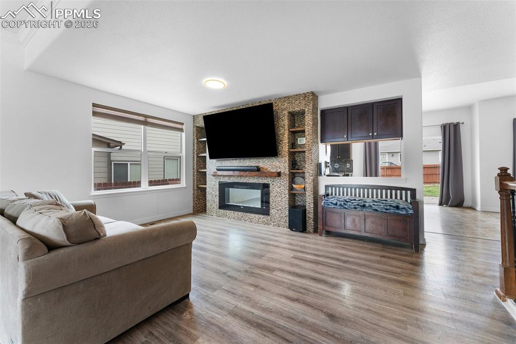 Main Level Living Room with Electric Fireplace and Built-In Shelving