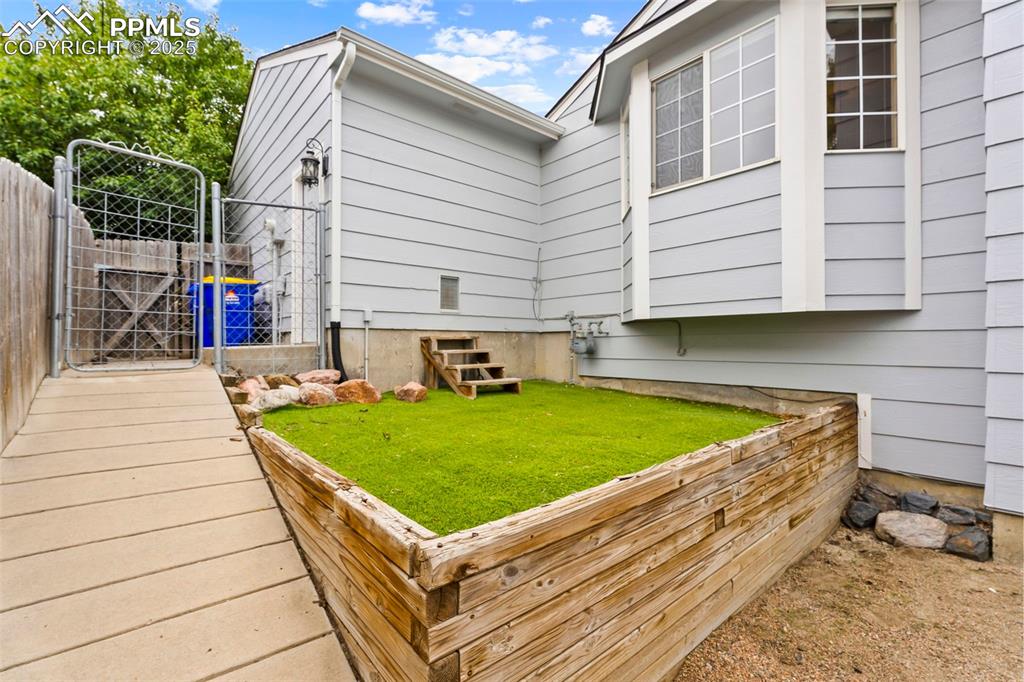 Turfed area with pet door into garage. 
