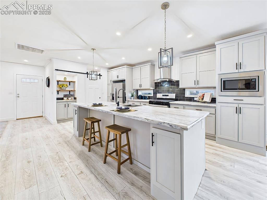 Expansive countertops with room for seating and meal prep, highlighted by modern cabinetry and finishes.