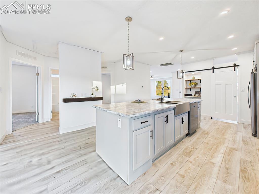 View from the island showcasing open flow into the Bedroom hall and abundant natural light.