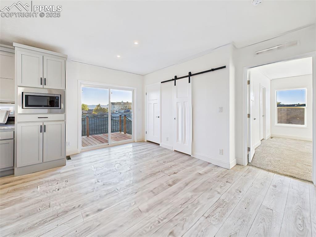 Bright dining area with sliding glass doors leading to the side west facing deck—perfect for indoor/outdoor dining BBQ and sunset views.