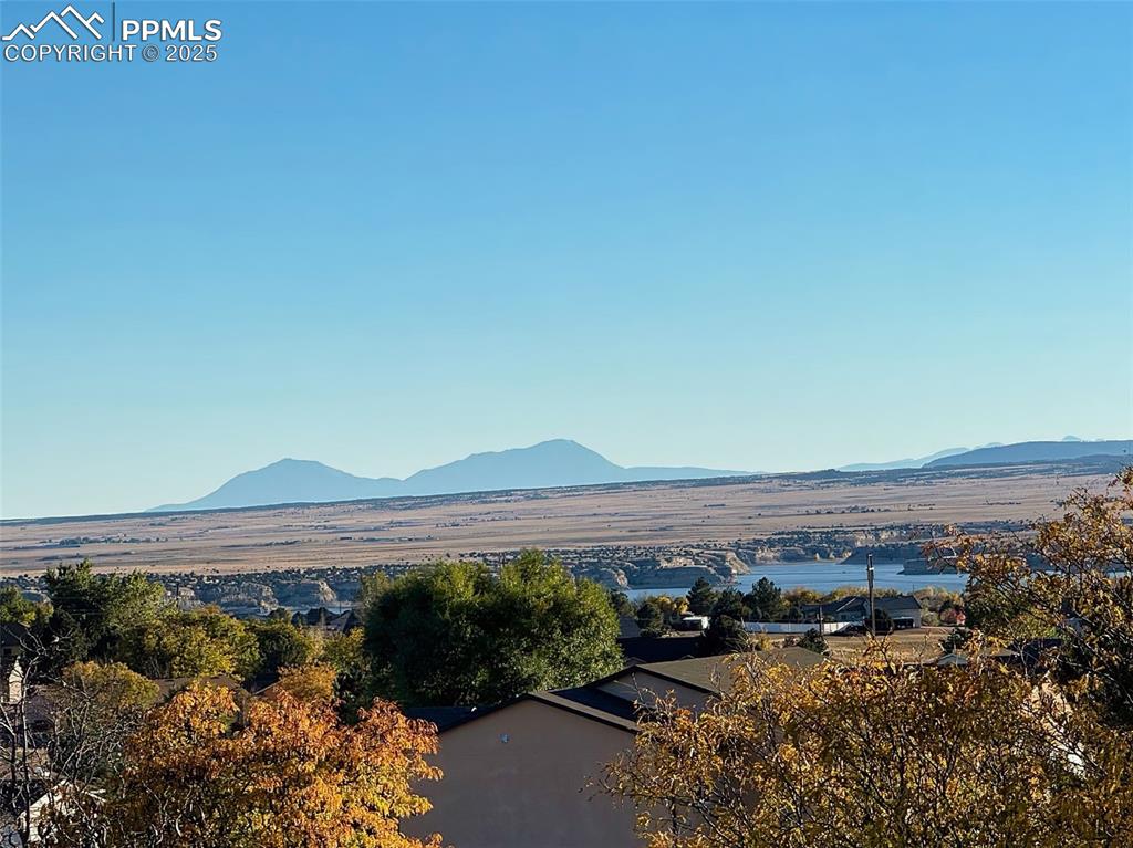 Unobstructed views of Pueblo Reservoir and the Spanish Peaks showcasing the home’s elevated setting.