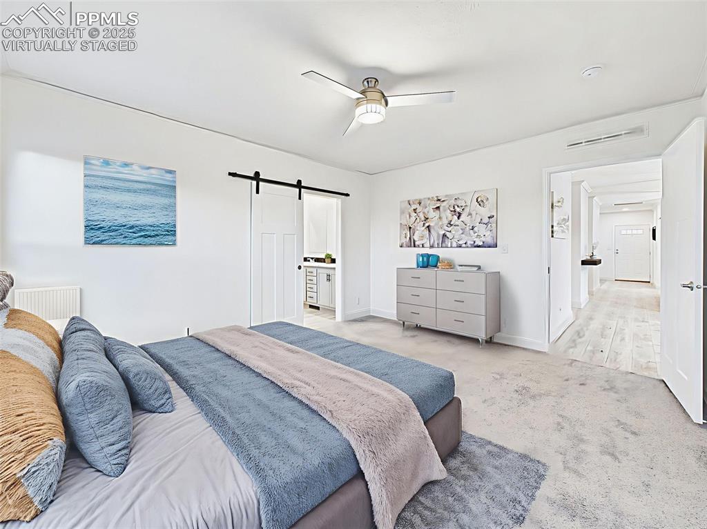 Virtually Staged Alternate view of the primary suite showing ensuite entry and spacious layout.