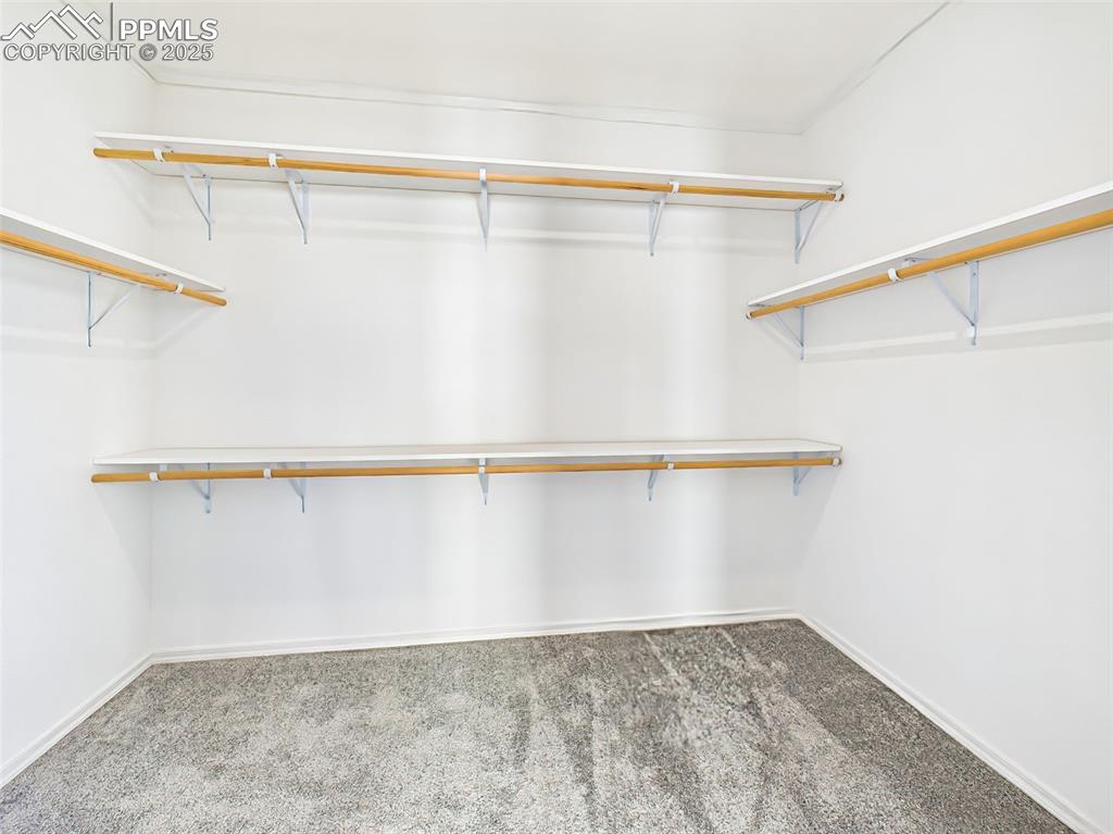 Generous walk-in closet with custom shelving and abundant storage.