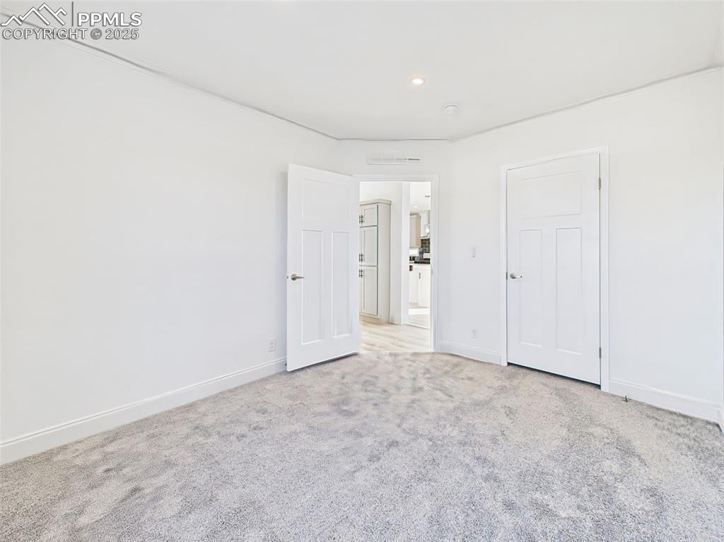 Un staged version bedroom 2 showing clean layout, fresh paint, and natural light.