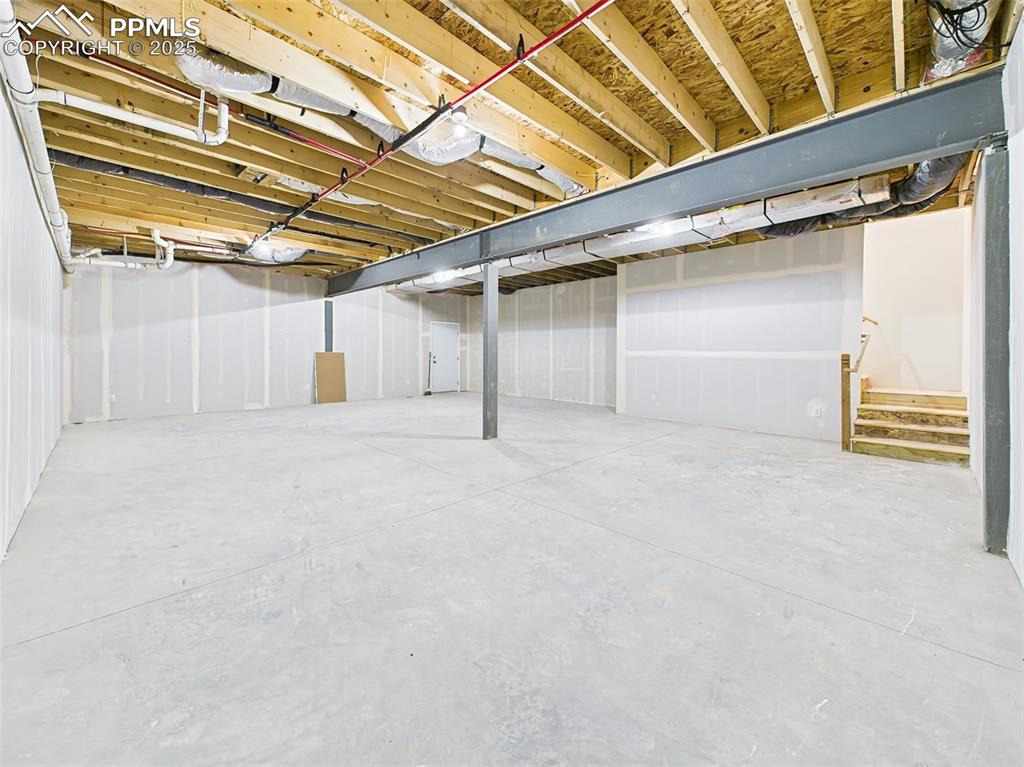 Expansive basement ready for customization—framed, insulated, and plumbed for future finishing 10' Ceiling.