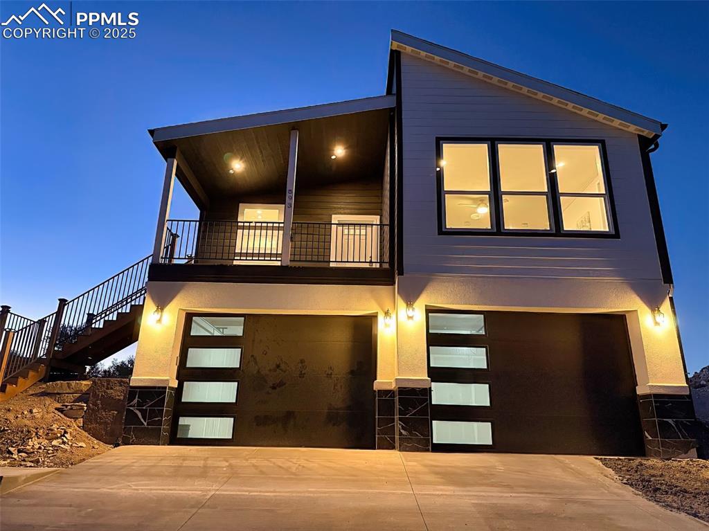 Evening view showcasing designer lighting and curb appeal.