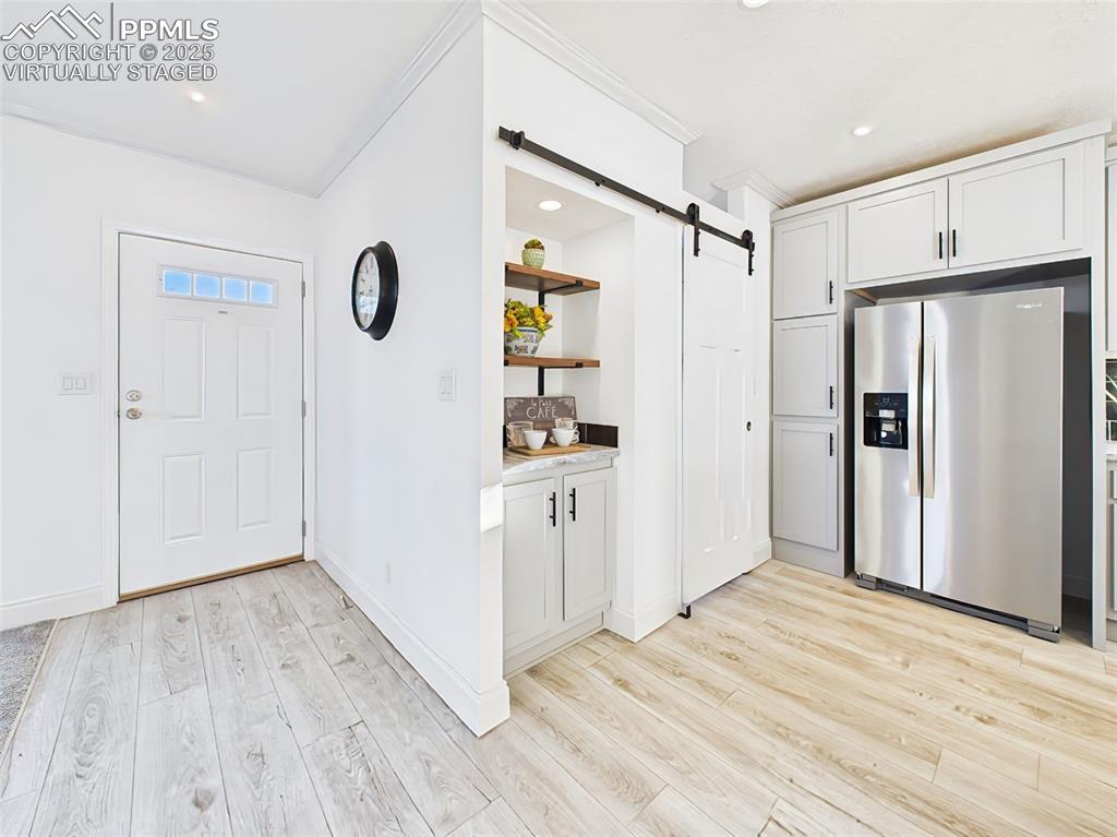 Bright, open living space with large picture windows, natural light—virtually staged to show layout potential.