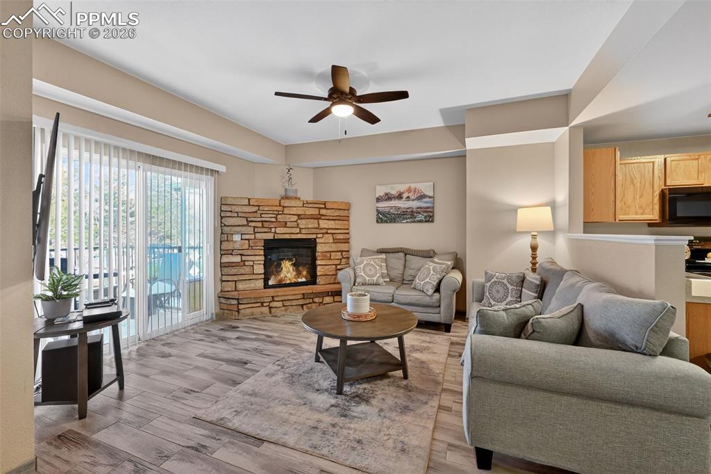 Cozy living room with gas fireplace and sliding glass door. 