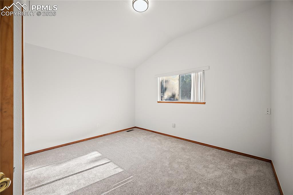Upstairs bedroom 3, vaulted ceilings and new carpet. 