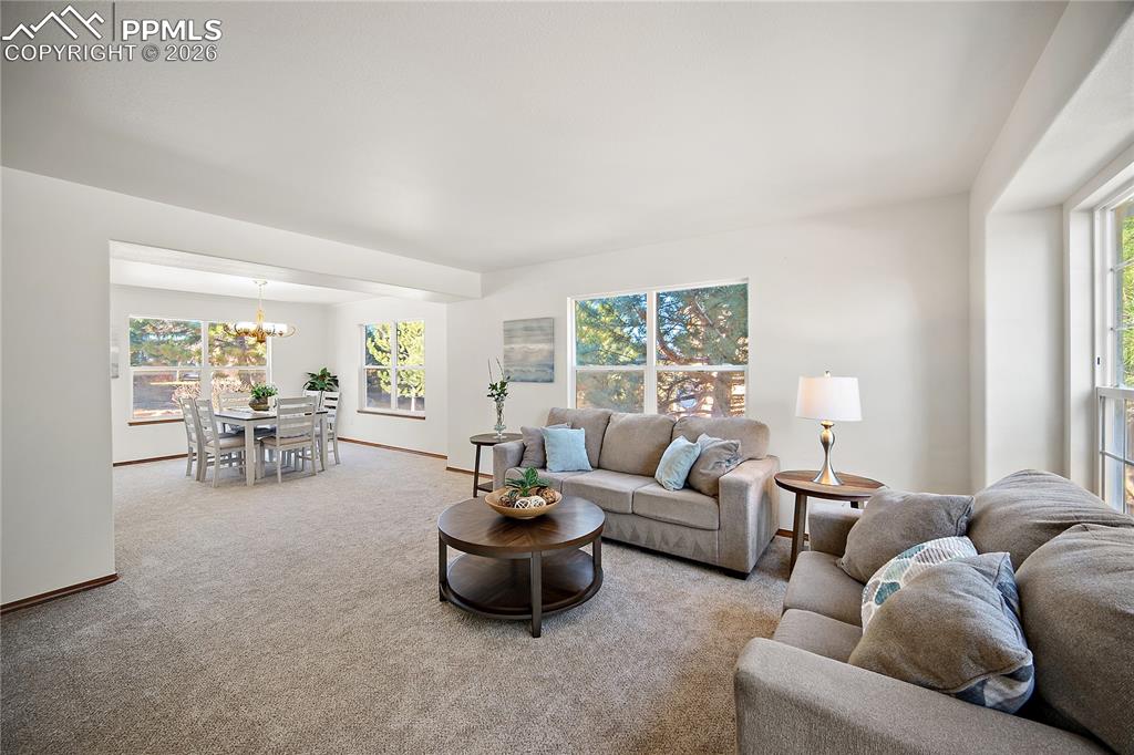 Formal living and dining rooms are open and bright. Large windows flood the space with natural light.