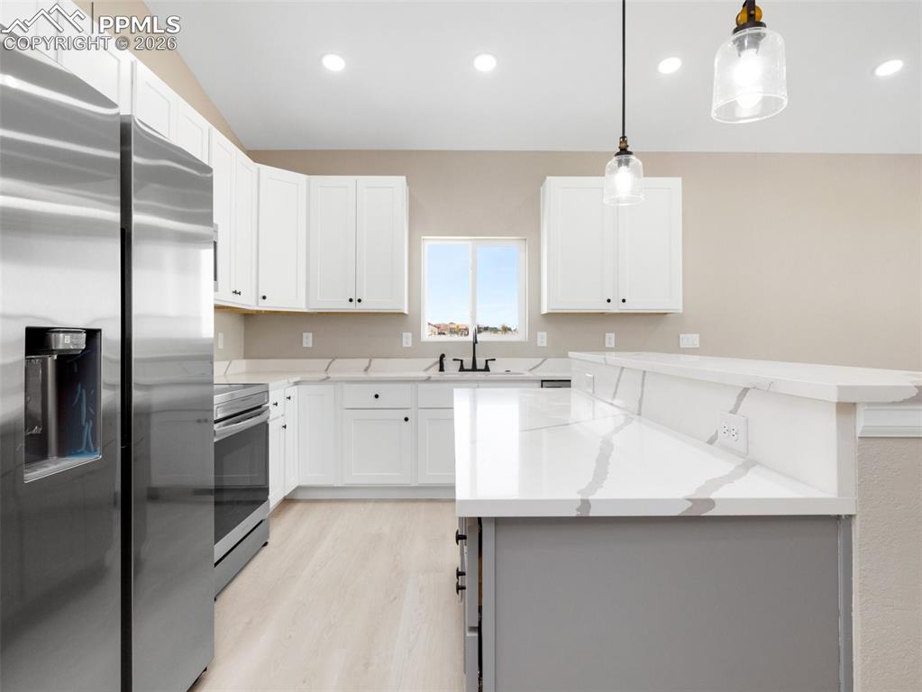 Wonderful kitchen with stainless appliances accented with quartz countertops, custom cabinets and a pantry! 