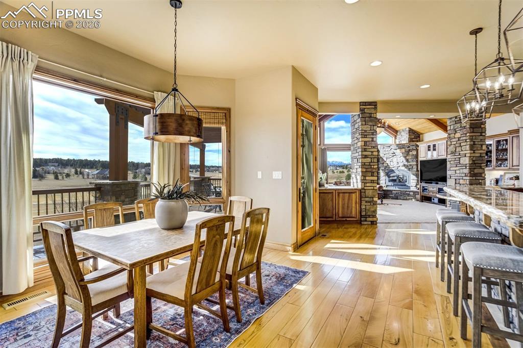 Tucked beside the windows, this dining nook offers peaceful views of the fairway below, where circling hawks and open skies make every meal feel connected to the Colorado landscape