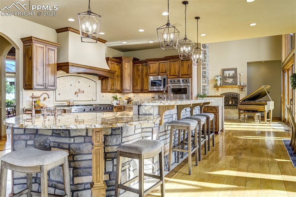 At the heart of the kitchen, the island—illuminated by new designer lighting—offers generous space to gather, share stories, and linger over meals together