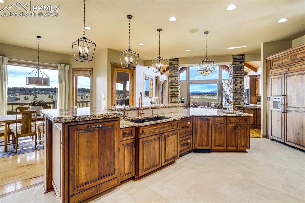 Walls of glass frame the landscape, always anchored by the timeless rise of Pikes Peak on the horizon