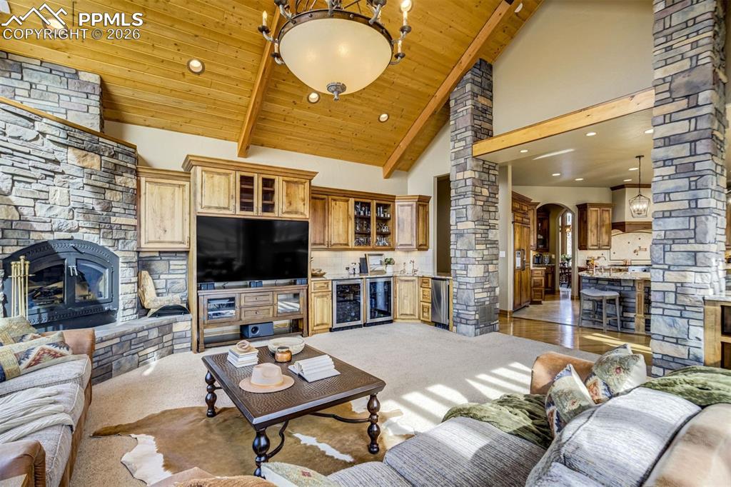 The heart of the home—soaring ceilings, stone fireplace, and a fully outfitted wetbar, create a lodge-like space designed for gathering, storytelling, and unforgettable evenings
