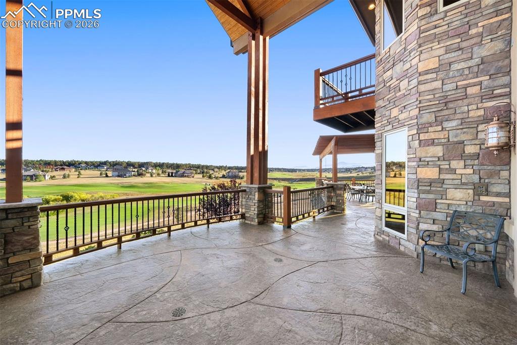 Beneath tall timber beams, the covered main-level deck offers a front-row seat to 180-degree views of the fairway and Colorado’s endless skies