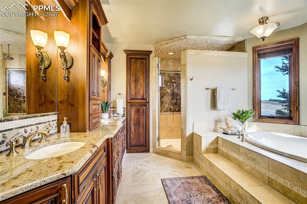 The spa-like bath offers space to unwind, with a soaking tub, generous walk-in shower, and thoughtful design that brings comfort and ease to everyday living