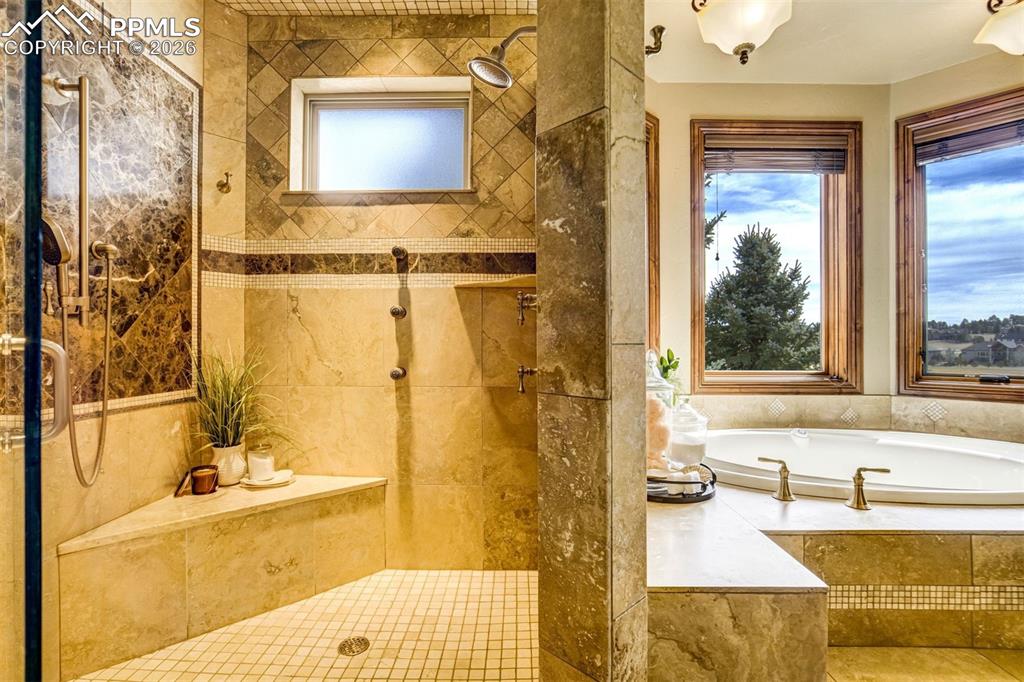 Bathed in natural light, the spa-inspired bath offers a peaceful place to unwind with a soaking tub, generous walk-in shower, and thoughtful design throughout